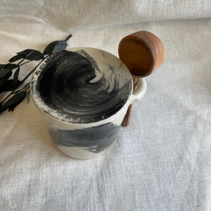 Ceramic canister with wooden spoon