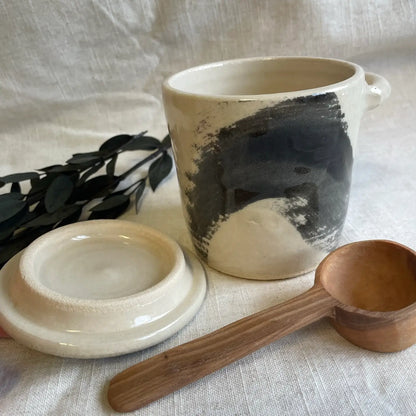 Ceramic canister with wooden spoon